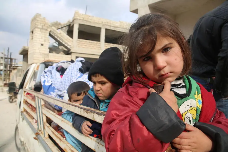Syrian refugee children flee violence on the back of a truck in the middle of winter. Syrian refugee children flee violence on the back of a truck in the middle of winter.