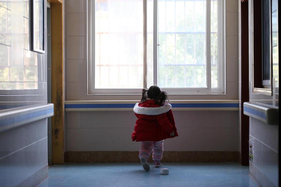 Five-year-old Yuanyuan walks the corridor of a hospital affiliated to the Wuhan University of Science and Technology in China on 17 February 2020.