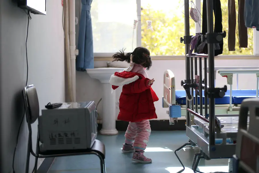 A 5-year-old girl whose entire family was admitted to the hospital after testing positive for coronavirus is watched over by hospital workers. A 5-year-old girl whose entire family was admitted to the hospital after testing positive for coronavirus is watched over by hospital workers.
