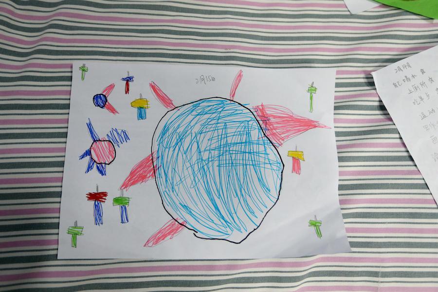 A drawing by 5-year-old Yuanyuan depicts the novel coronavirus surrounded by hammers.“This is a virus, and these hammers are striking it,” she says.
