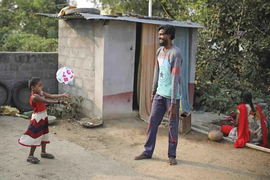 Rishitha, who lives in the village of Perleakondaram in India is pictured playing with her dad at home.