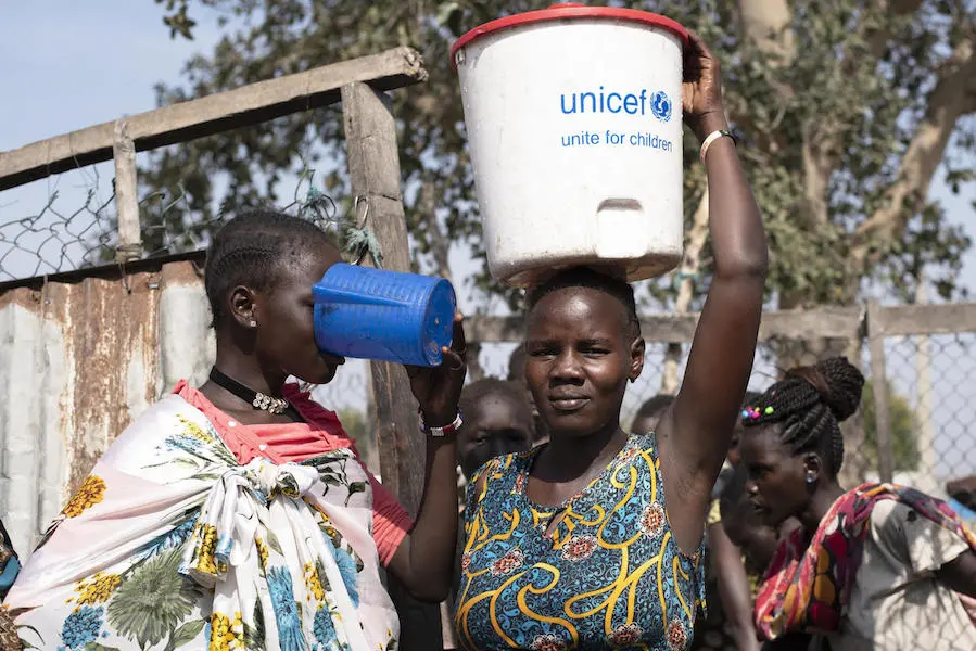 Families can fill their buckets with safe drinking water at one of the 16 water points near the UNICEF-supported Rubkona water treatment facility in South Sudan. Families can fill their buckets with safe drinking water at one of the 16 water points near the UNICEF-supported Rubkona water treatment facility in South Sudan.