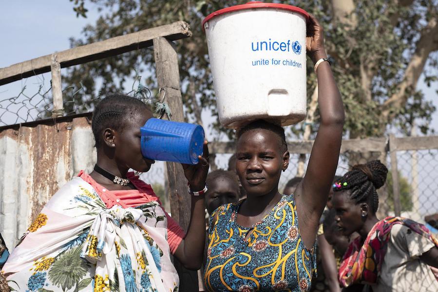 Families can fill their buckets with safe drinking water at one of the 16 water points near the UNICEF-supported Rubkona water treatment facility in South Sudan. 