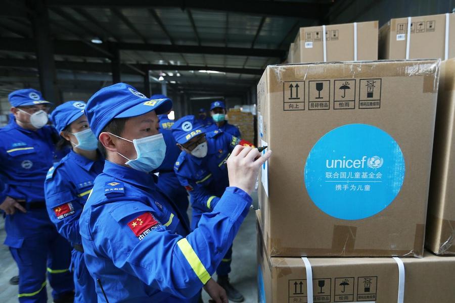 Volunteers check and accept UNICEF donated supplies in an emergency warehouse of the Hubei Charity Foundation in Wuhan, the epicenter of the COVID-19 outbreak, on March 18, 2020.