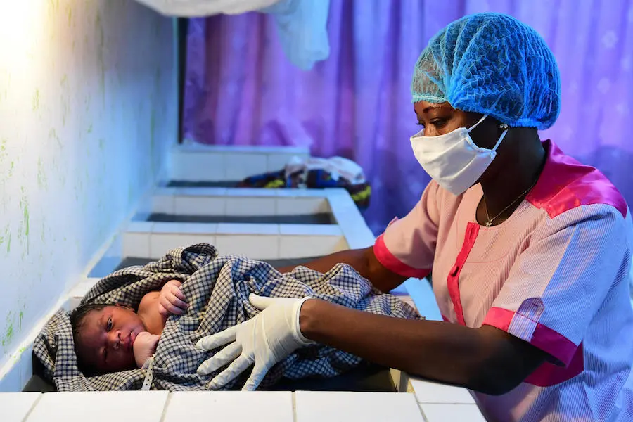 A nurse wears a mask and gloves to protect against the novel coronavirus in the health center of Port Bouet, a suburb of Abidjan, Côte d'Ivoire. A nurse wears a mask and gloves to protect against the novel coronavirus in the health center of Port Bouet, a suburb of Abidjan, Côte d'Ivoire.