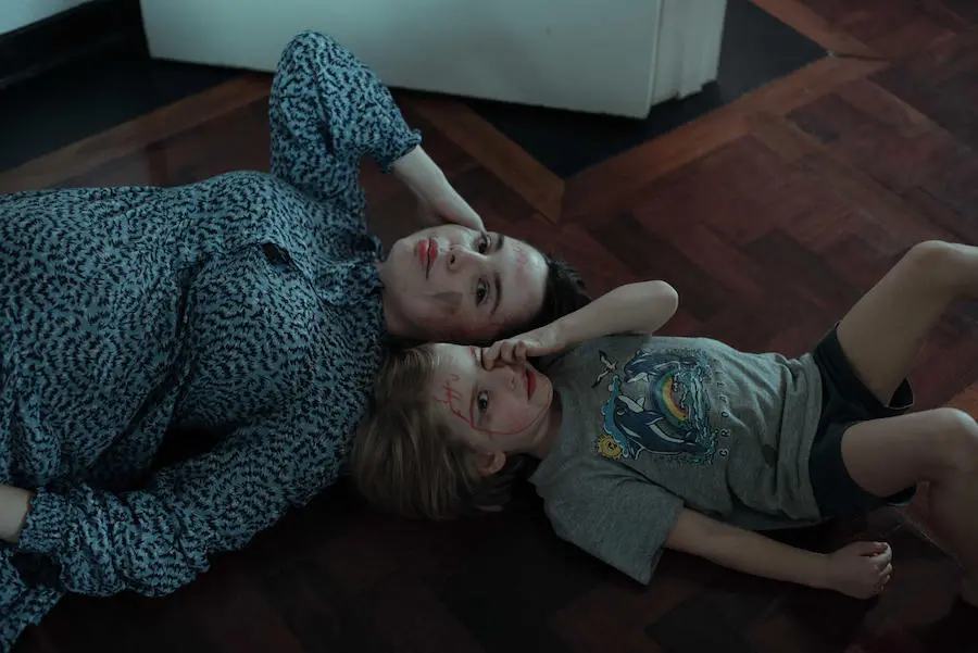Woman and Child Laying on the Ground