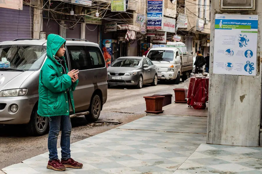 On April 1, 2020, a boy reads a UNICEF poster sharing practical advice on how to prevent the spread of the novel coronavirus in Qamishly, a city of some 250,000 in northeast Syrian Arab Republic. On April 1, 2020, a boy reads a UNICEF poster sharing practical advice on how to prevent the spread of the novel coronavirus in Qamishly, a city of some 250,000 in northeast Syrian Arab Republic.