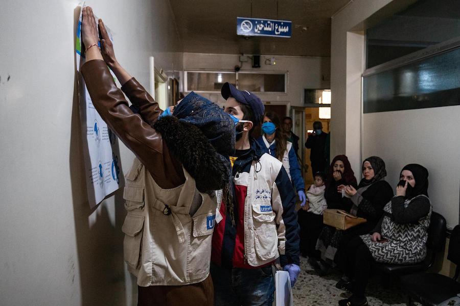 On April 1, 2020, UNICEF volunteers hang posters providing important instructions on how to protect against COVID-19 in a clinic in Qamishly, a city of some 250,000 in northeast Syrian Arab Republic.&nbsp;