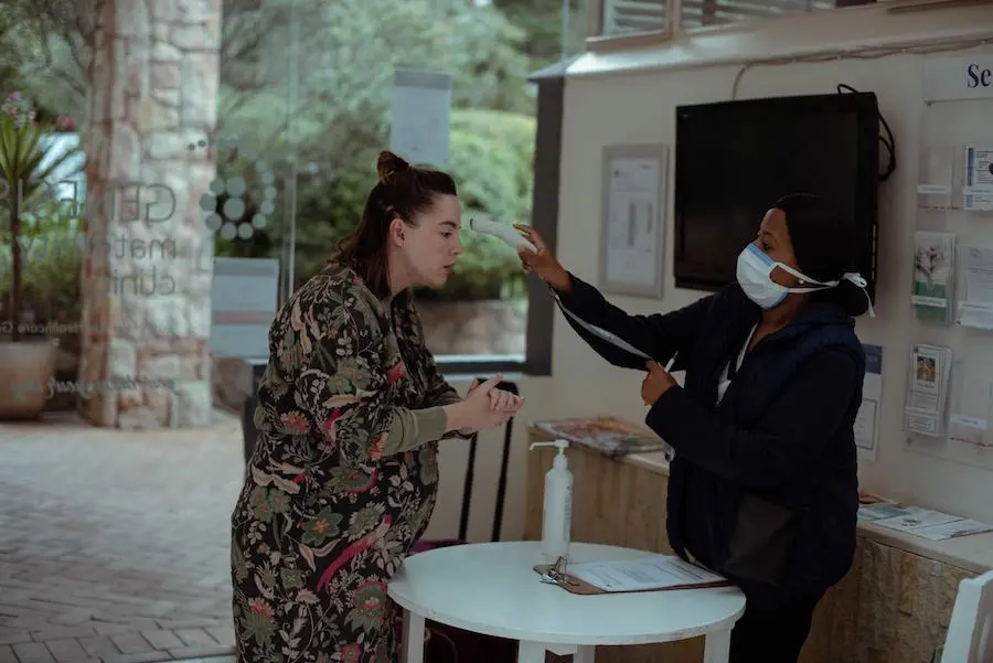 Woman Getting Temperature Taken