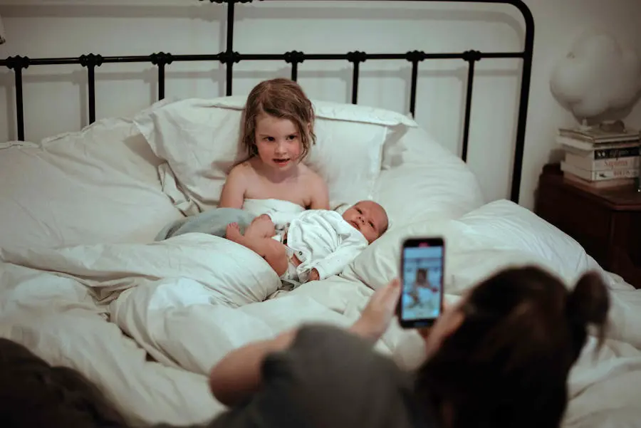Young Child Holding Newborn