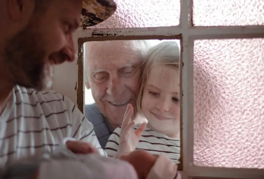 Child Meeting Baby Through Window