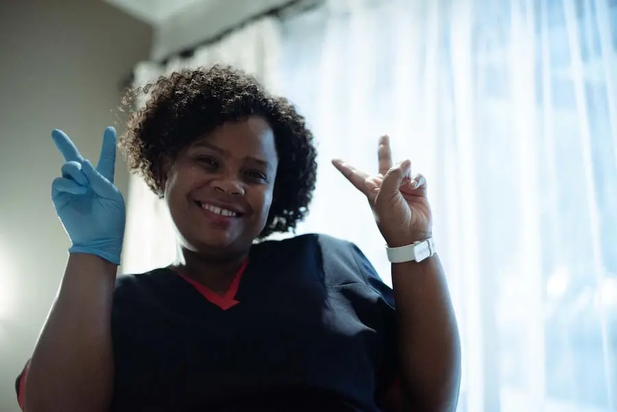 Medical Worker Holding Up Two Peace Signs