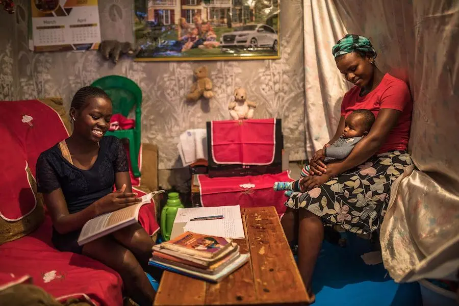 Sandra Achieng and her mom Winnie at their home in Kibera. The Kenya government gave directives that all school to be closed to curb the spread of the COVID-19 pandemic, Sandra always gets revision assignments from her classteacher via her father's smartp Sandra Achieng and her mom Winnie at their home in Kibera. The Kenya government gave directives that all school to be closed to curb the spread of the COVID-19 pandemic, Sandra always gets revision assignments from her classteacher via her father's smartp