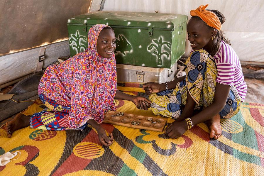 Two friends play a traditional game at the UNICEF-supported Child-Friendly Space at the Socoura displacement camp in Mopti, central Mali