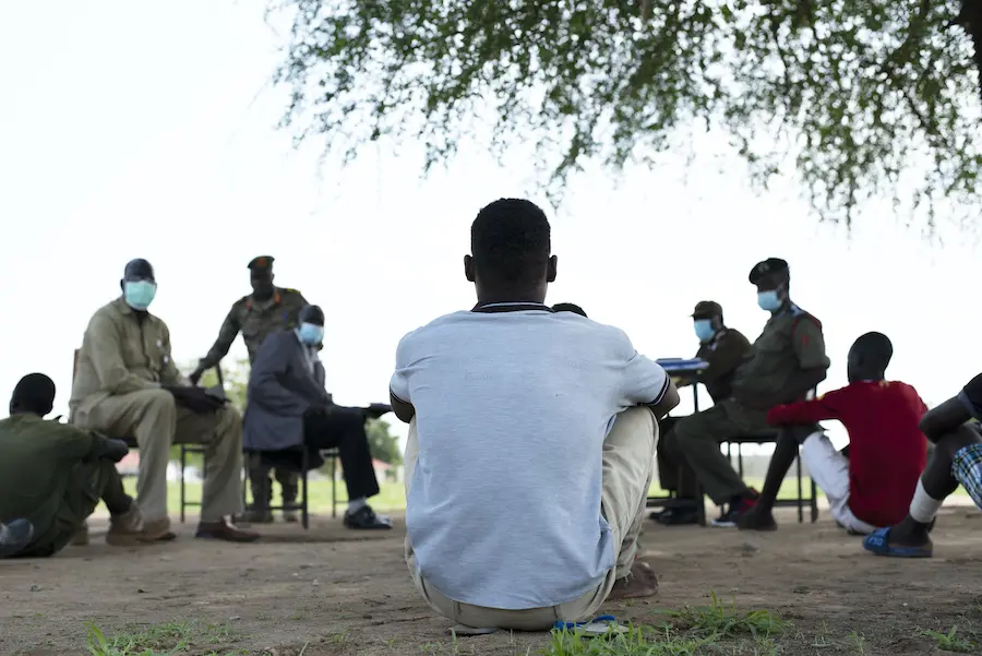 Men Sitting on the Ground Outside