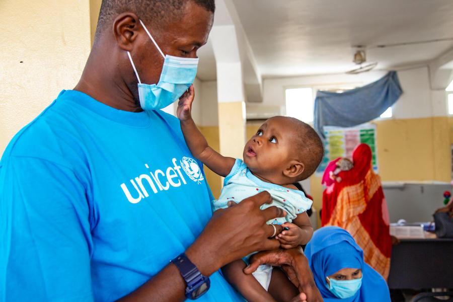 A UNICEF nutrition specialist holds a baby being treated for malnutrition at the UNICEF-supported Dar Naim nutrition rehabilitation center in Nouakchott, Mauritania.