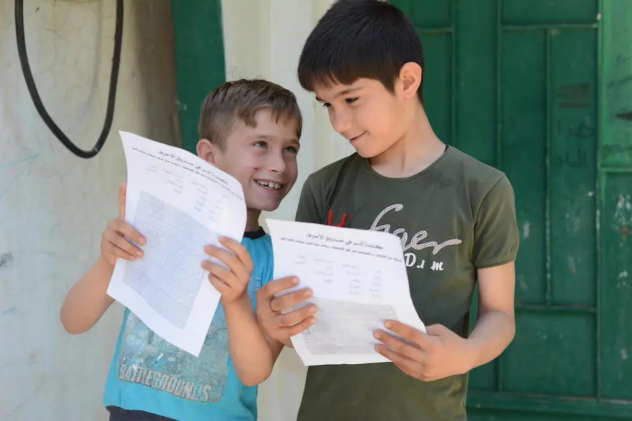 On May 14, 2020, children check paper exercises brought to them at home by UNICEF-supported volunteers during COVID-19 lockdown in Teir-Ma'aleh, northern rural Homs, Syrian Arab Republic. On May 14, 2020, children check paper exercises brought to them at home by UNICEF-supported volunteers during COVID-19 lockdown in Teir-Ma'aleh, northern rural Homs, Syrian Arab Republic.