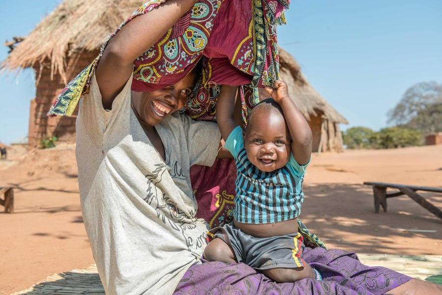 One-year-old baby Lucky and his mom play hide and seek in Zambia in 2020.