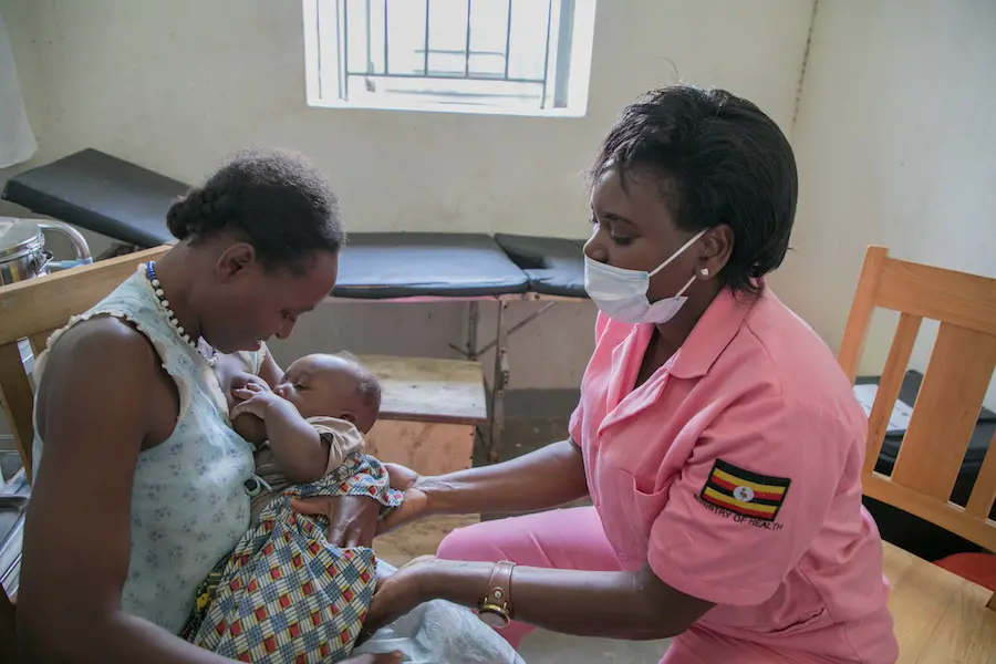 A UNICEF-supported midwife shows a mother best breastfeeding practices at Kasanda Health Center in central Uganda in 2020. A UNICEF-supported midwife shows a mother best breastfeeding practices at Kasanda Health Center in central Uganda in 2020.