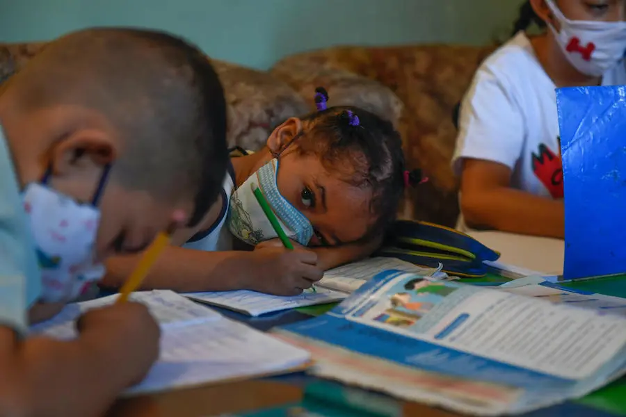 Children attend class in an improvised classroom in a house in the Petare neighborhood, Venezuela's largest slum, in Caracas, amid the COVID-19 pandemic. Children attend class in an improvised classroom in a house in the Petare neighborhood, Venezuela's largest slum, in Caracas, amid the COVID-19 pandemic.