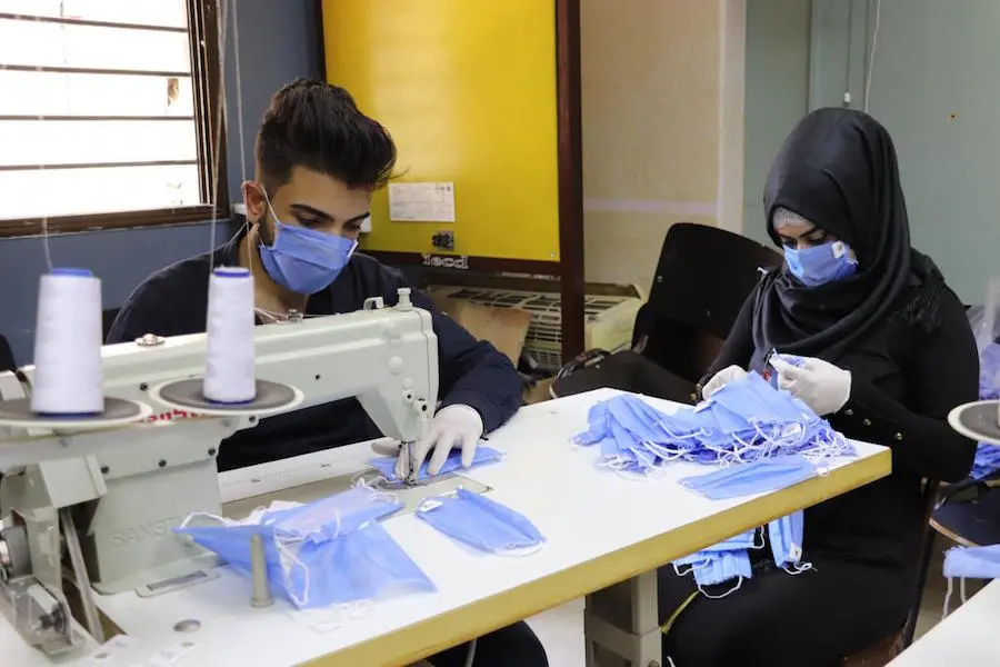 Muhannad, 18, and Fatima, 17, are trainees in a sewing course at a UNICEF-supported youth center in rural Damascus, Syria. They are making masks to protect their community from COVID-19.