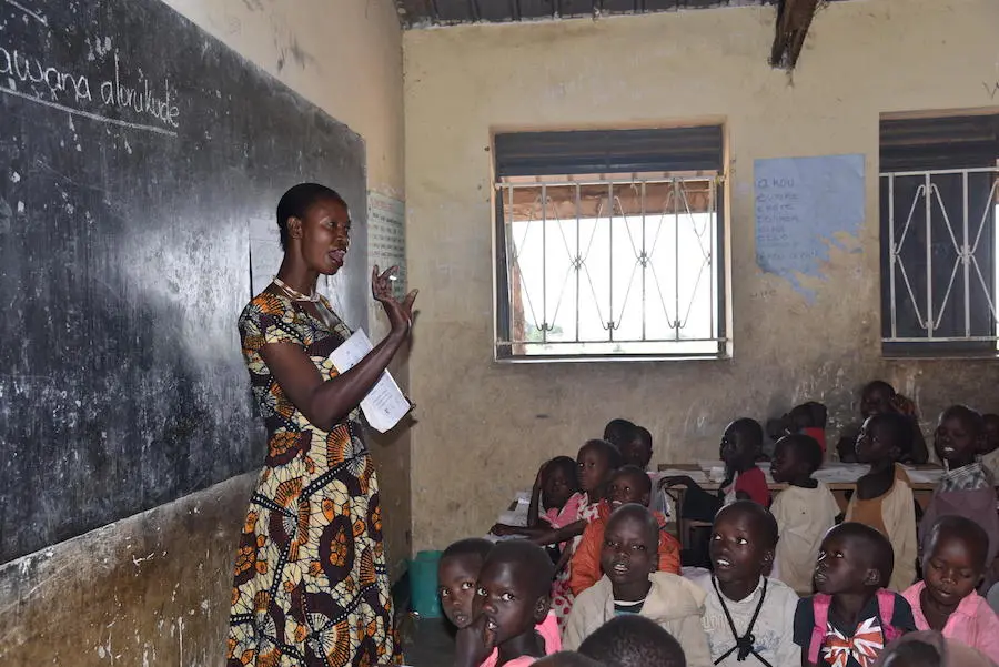 Teacher Goretti Arot with her students in Longalom Primary School, Uganda. She received teacher training and mentoring from Voluntary Services Overseas, supported by UNICEF with funding from Irish Aid. unicef, education, uganda, teachers