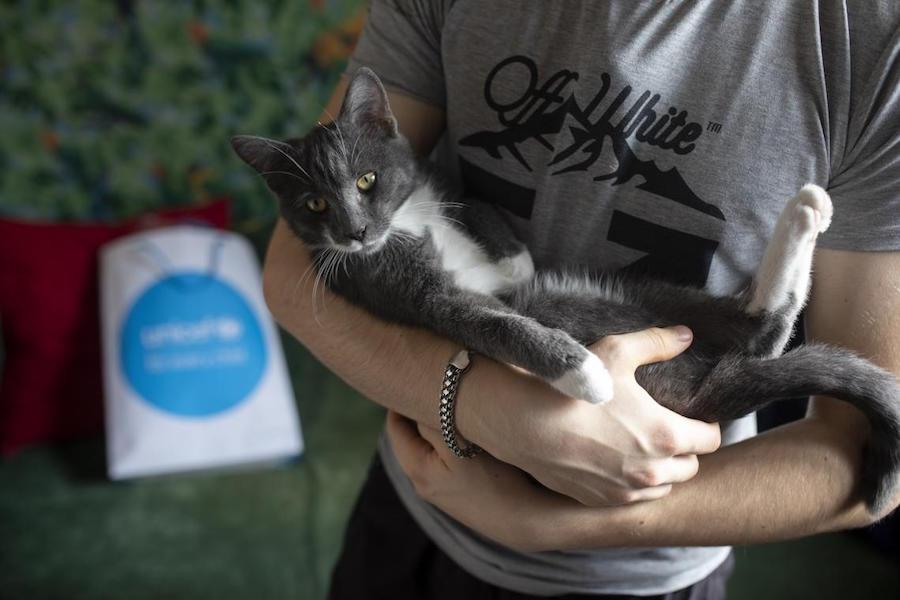Illia, 16, holds his pet cat at his home in eastern Ukraine.