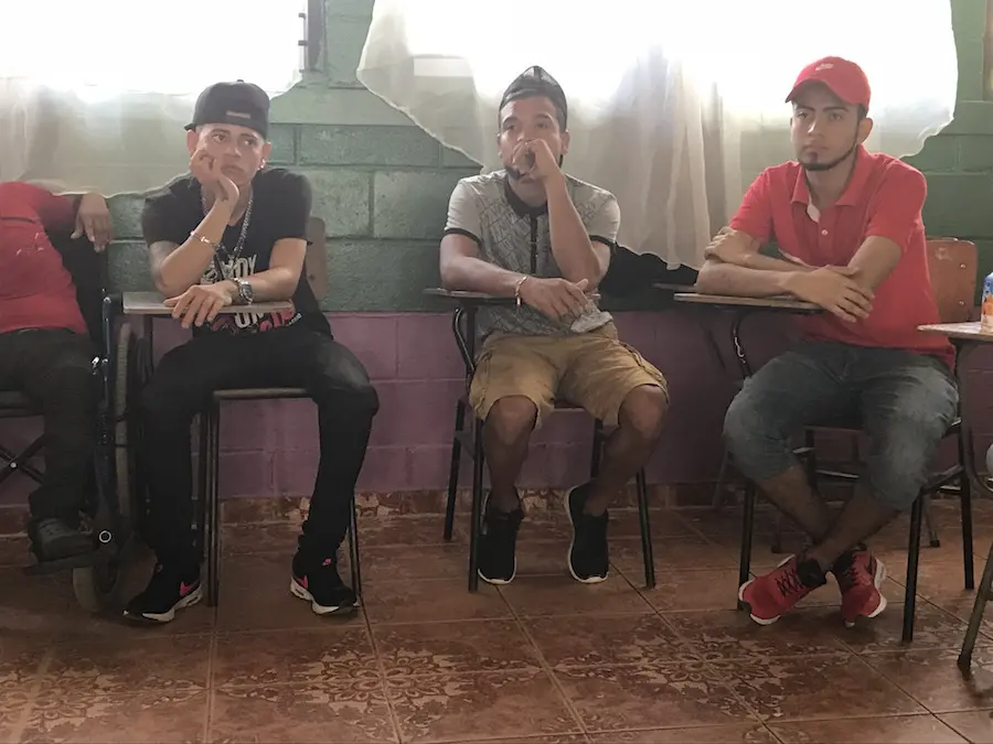 Young Men Sitting at School Desks