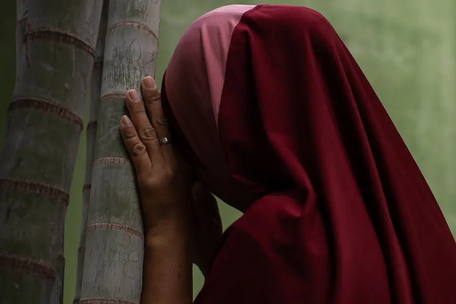 Girl Hiding Face Against Tree