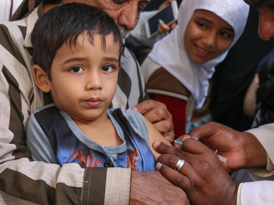 A boy receives a measles and rubella vaccine during a UNICEF-backed mobile vaccination campaign in Aden, Yemen in February 2019. 