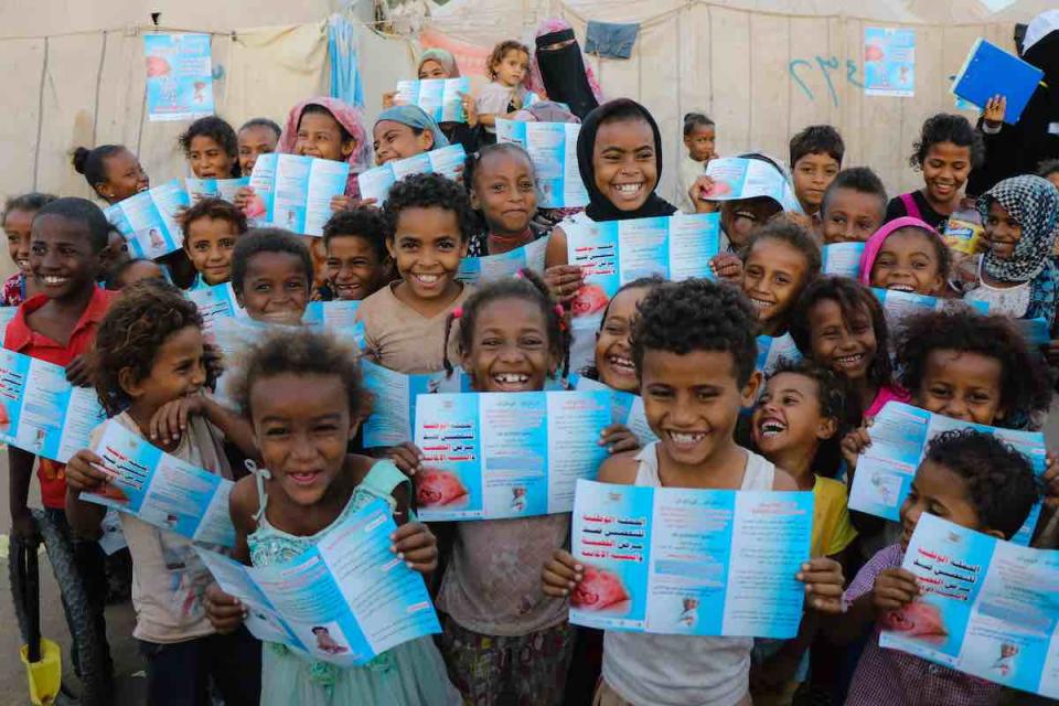 A group of children in Aden, Yemen read brochures about the Measles and Rubella vaccine they are about to receive on 9 February 2019. Following a measles outbreak of more than 6,000 cases in 2018, UNICEF and partners stepped up efforts to ensure all child