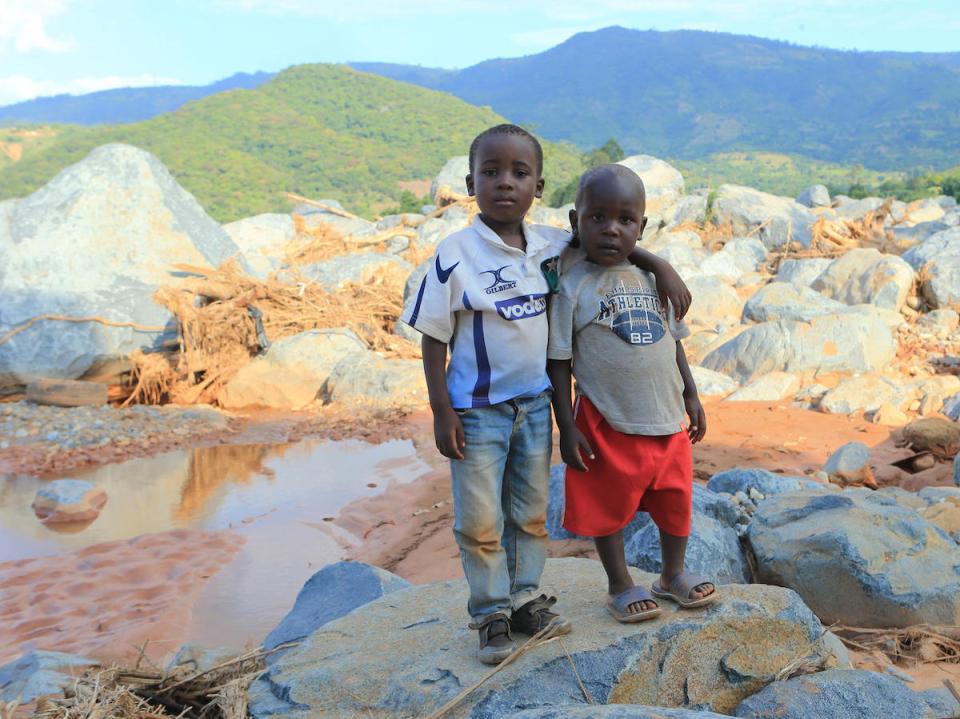 Brothers Anesu (left) and Future near the spot where their house was swept away when Cyclone Idai hit Zimbabwe in March 2019. 