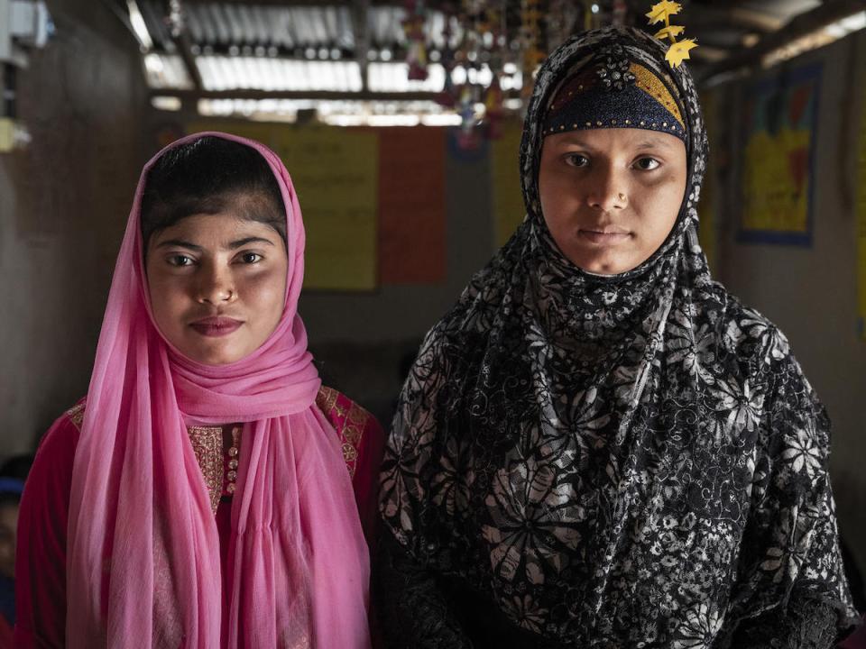 Yasmin (left), 12, a Bangladeshi national, and Showkat, 15, a Rohingya refugee, both attend a UNICEF-supported adolescent club in Lambasia refugee camp, Cox's Bazar, Bangladesh on 24 June 2019. 