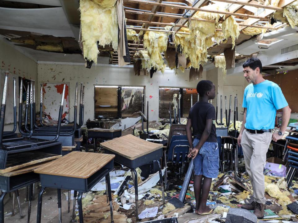 On 7 September 2019, in Marsh Harbour, Abaco Island, Bahamas. In the aftermath of Hurricane Dorian, Torres, 10, talks to UNICEF’s Regional Emergency Specialist Hanoch Barlevi in his totally destroyed classroom in Central Abaco public school. 