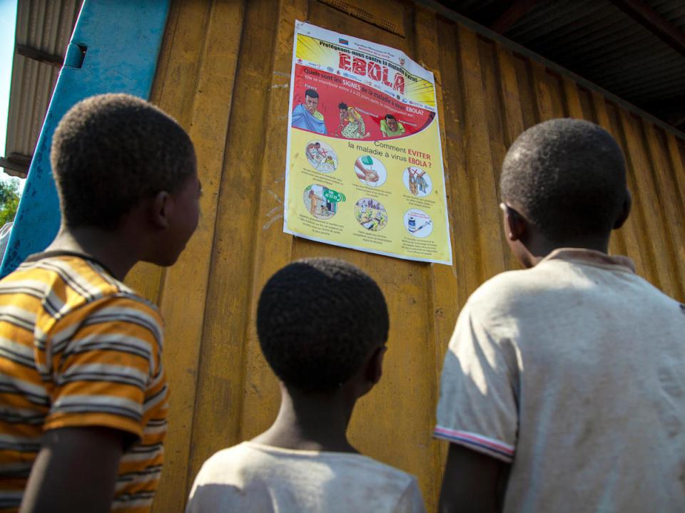 Children read an Ebola-awareness poster in North Kivu, the Democratic Republic of the Congo (DRC).