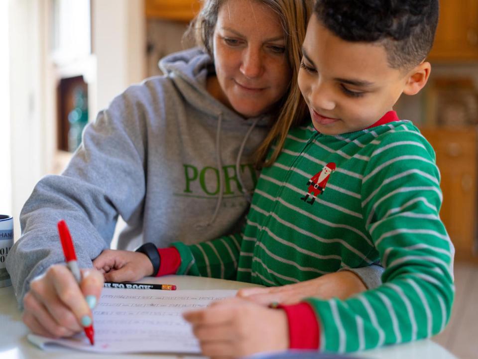 On the morning of 16 March 2020, 8-year-old second grader Luka works on a mathematics assignment at home in Connecticut, United States of America, with help from his mother, Sophia.