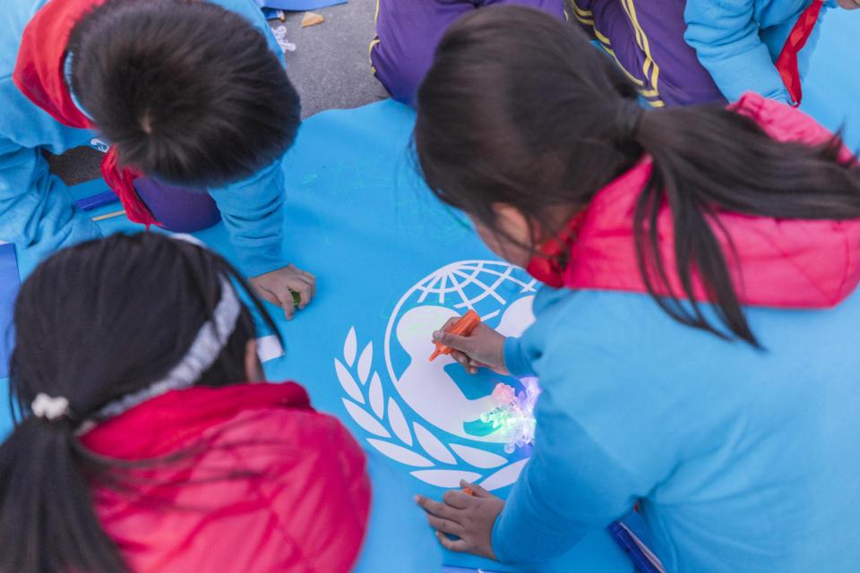 Children from Beijing write down their wishes to share with peers around the world at the Olympic Park in Beijing, China, on 20 November 2019.