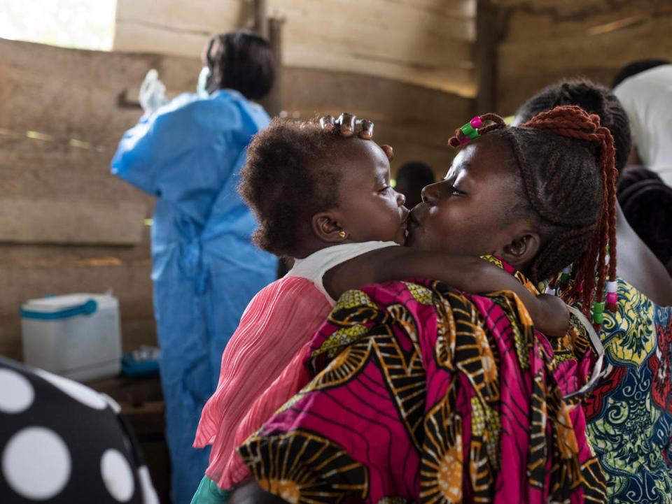 A mother kisses her daughter at a regularly scheduled, UNICEF-supported immunization clinic in the village of Kuka on the outskirts of Beni in North Kivu province, Democratic Republic of the Congo on 21 October 2019. 