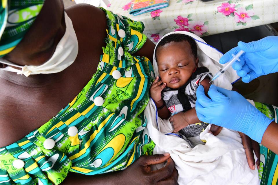 A nurse vaccinates a baby at the health center in Gonzagueville, a suburb of Abidjan, Côte d'Ivoire, where masks and gloves are worn to protect against COVID-19.