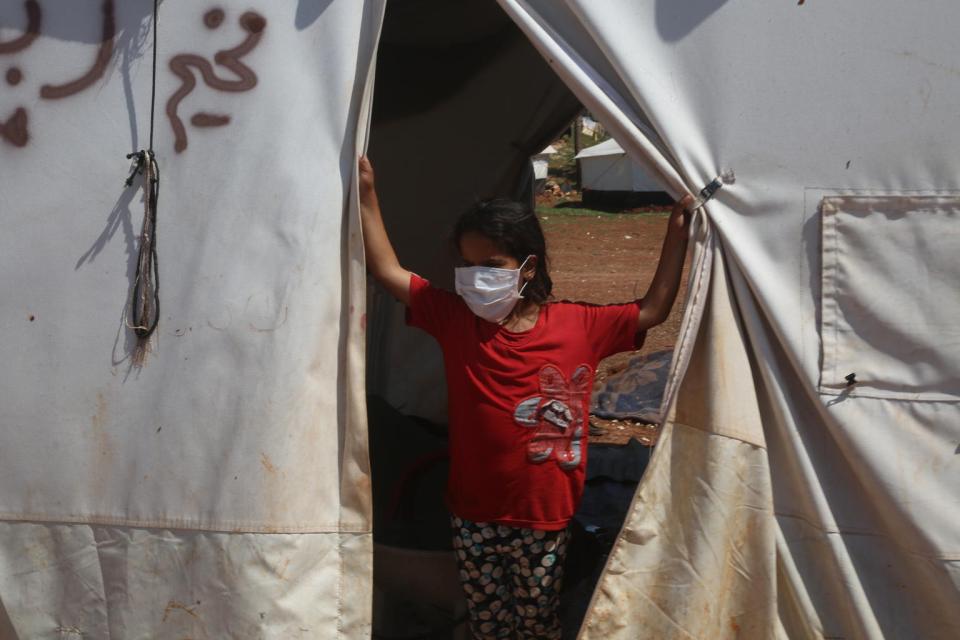 On 19 April 2020, volunteers share messaging around staying safe and healthy during the time of the COVID-19 outbreak, in a tent camp for displaced Syrians near the town of Kafr Yahmoul, north of Idlib, Syrian Arab Republic.