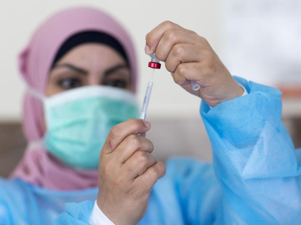 On 3 May 2020, nurse Hana Barakat prepares a vaccine at the Ministry of Health clinic in Ramallah, State of Palestine.