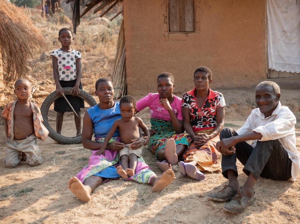In Malawi's Ntcheu District, Wilson Kamwana, 84, far right, and his extended family use the $7 a month they receive from a UNICEF-supported unconditional cash transfer program to pay for basic necessities like soap, salt, sugar and school supplies. 