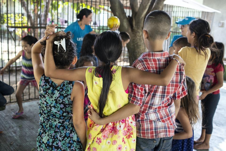 A UNICEF-supported volunteer plays with children at the St. Augustine hotel for refugees and asylum seekers in Tapachula, Mexico.