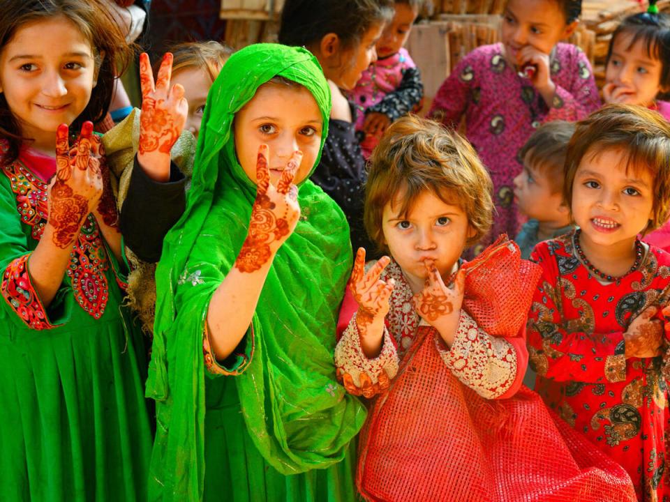 Girls ages 3 to 5 welcome the UNICEF-supported polio vaccination team to Lahore, Pakistan in January 2021.