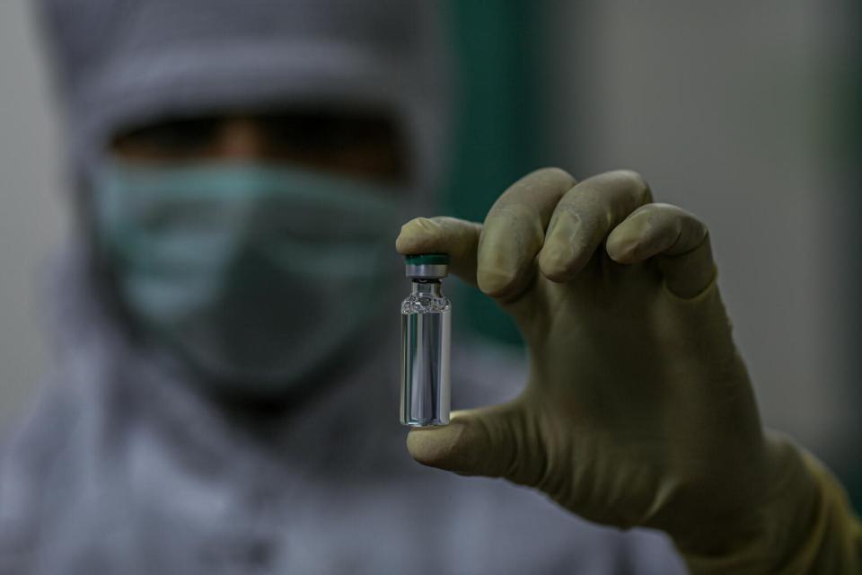 On 24 February 2021, an employee holds a COVID-19 vaccine vial produced for the COVAX facility at a manufacturer in Pune, a city located in the western Indian state of Maharashtra.