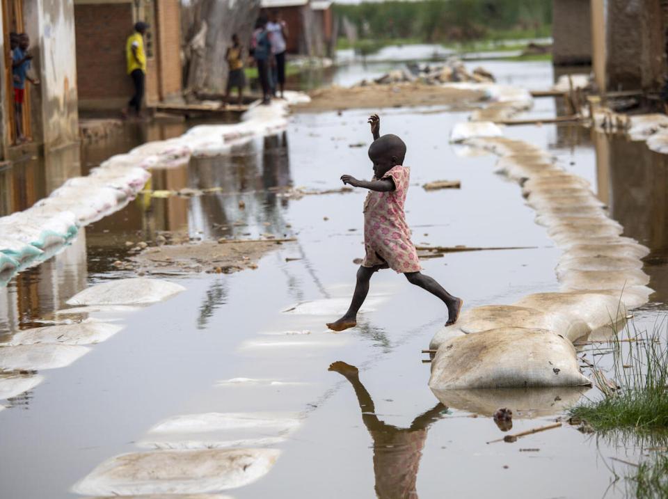 On March 4, 2021, a child plays in the floodwaters in Gatumba, located near Bujumbura in Burundi. 