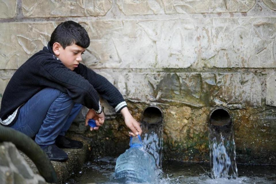 In Wadi El Jamous, Lebanon, Adham, 11, fetches water for his family from the village well.