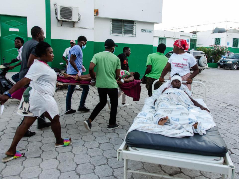 Patients are transported for care at Immaculate Conception Hospital in Les Cayes, Haiti on August 15, 2021, following the 7.2 earthquake that struck the region on August 14, 2021.