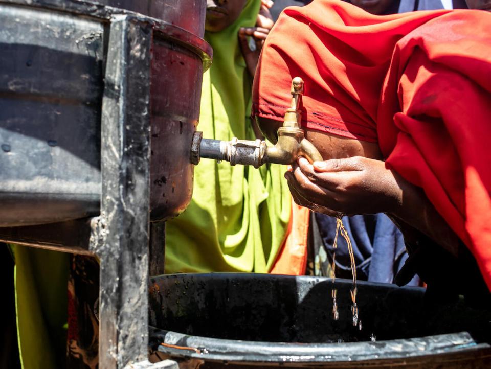 A student takes a drink as she washes her hands at the UNICEF-supported Qansaxleey Primary and Secondary school playground in Dolow, Somalia.