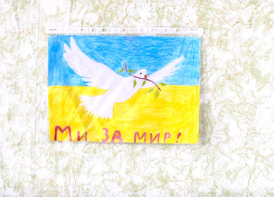 A child's drawing promoting peace hangs on the wall of an empty school in eastern Ukraine on February 10, 2022. 